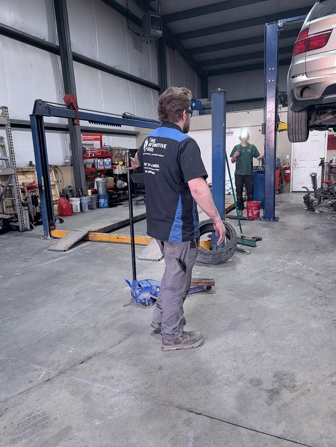 A technician in a branded uniform in the shop