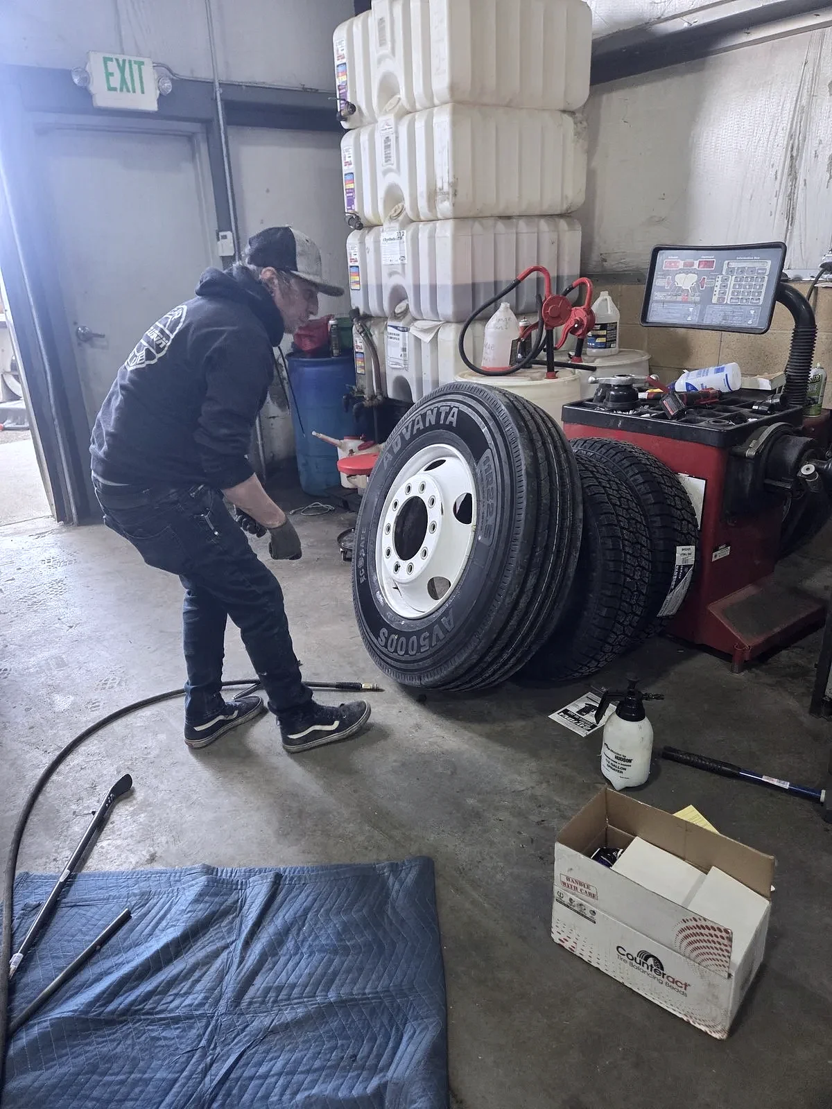 A technician in uniform performing tire and wheel service at The Automotive Shop in Jerome, Idaho